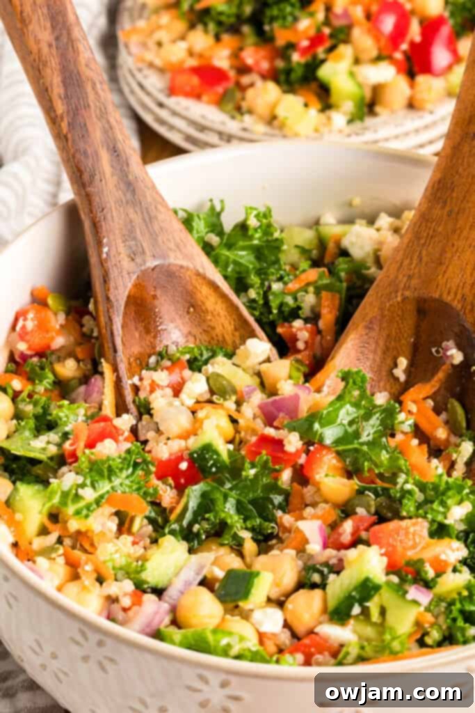 Healthy Kale Chickpea Salad 2 Kale Chickpea Salad with serving spoons in bowl