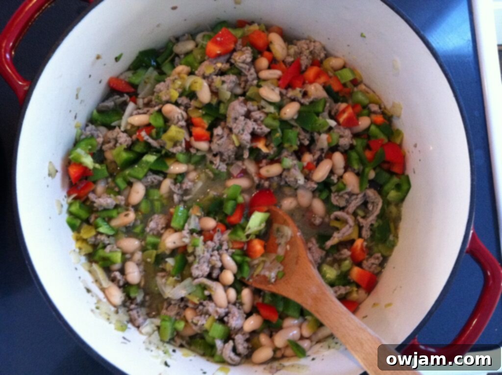 A large pot brimming with delicious Cajun Green Chili, showcasing its rich, green hue