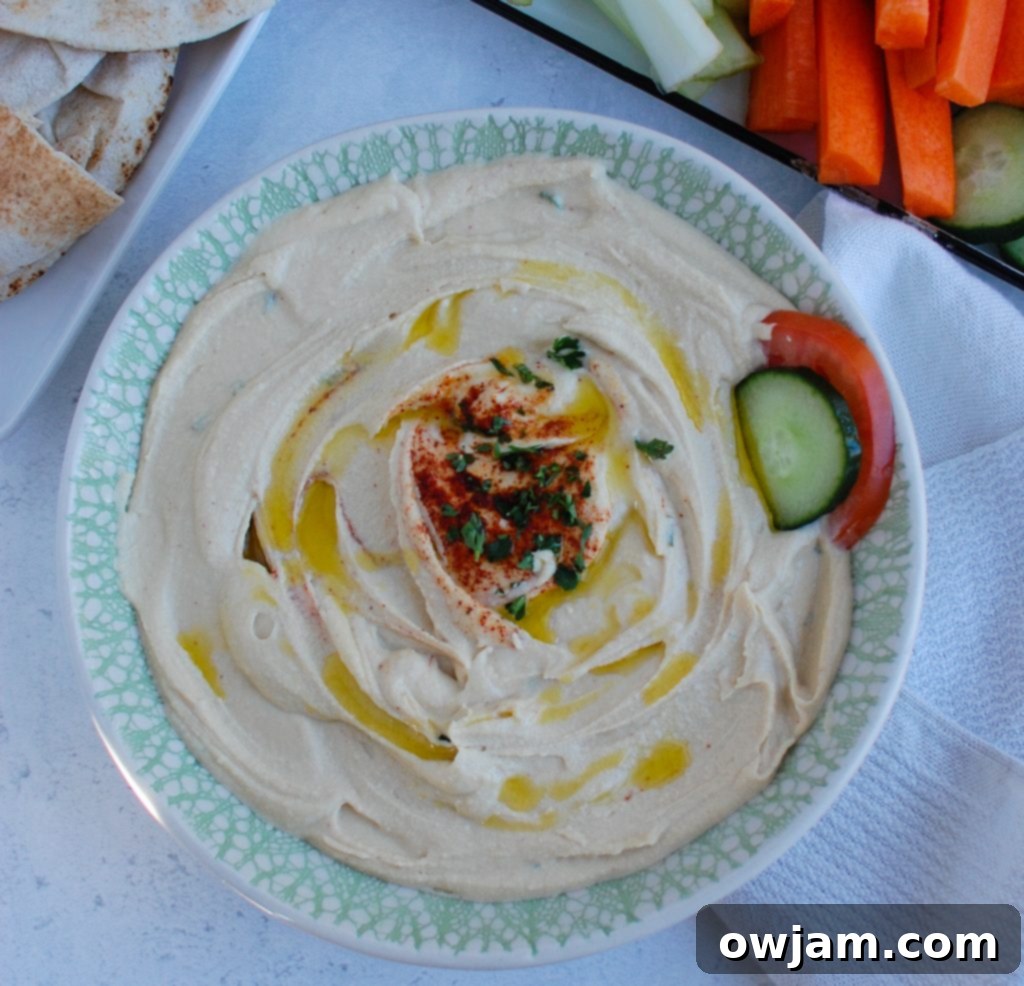 Master the Art of Lebanese Hummus 4 Homemade Lebanese Hummus in a bowl with a red napkin, ready to be served