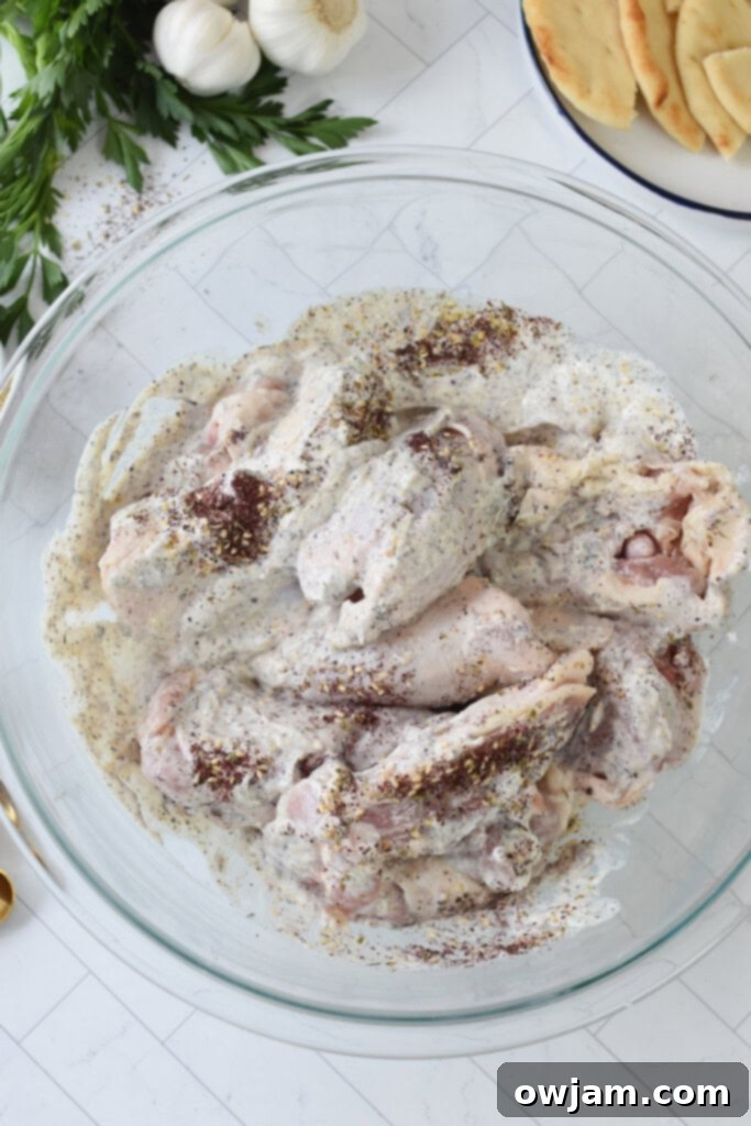One Pan Zaatar Chicken 10 Sheet Pan Za’atar Chicken marinading in a bowl