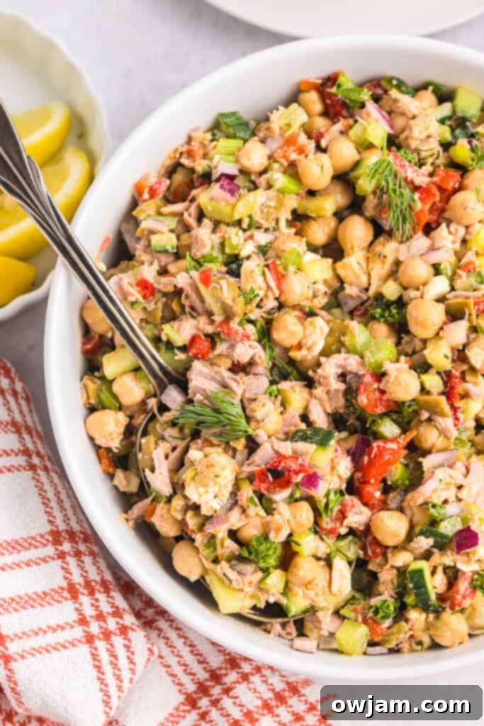 Refreshing Mediterranean Tuna and Chickpea Salad 2 Mediterranean Tuna and Chickpea Salad with a spoon, showing a vibrant mix of ingredients