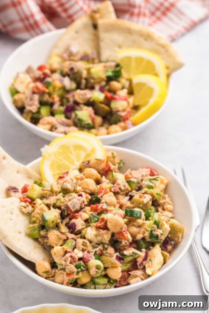 Refreshing Mediterranean Tuna and Chickpea Salad 6 Mediterranean Tuna and Chickpea Salad in two bowls, garnished