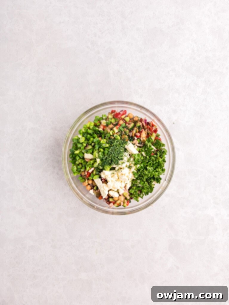Refreshing Mediterranean Tuna and Chickpea Salad 9 Mediterranean Tuna and Chickpea Salad ingredients in a bowl before mixing