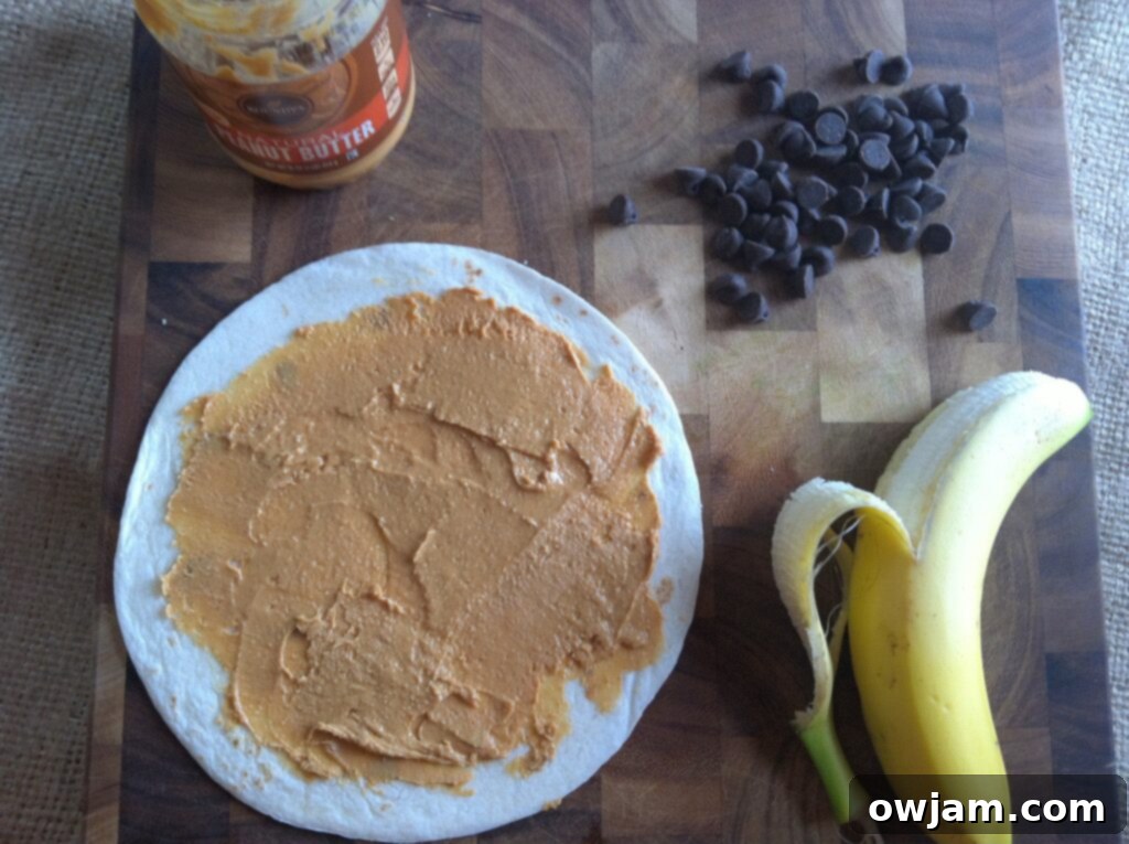 Spreading peanut butter on a tortilla for a Dulce Quesadilla.