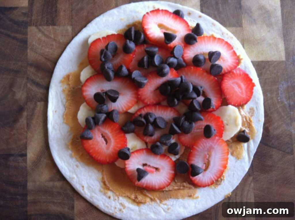 Chocolate chips sprinkled over strawberries on a Dulce Quesadilla.