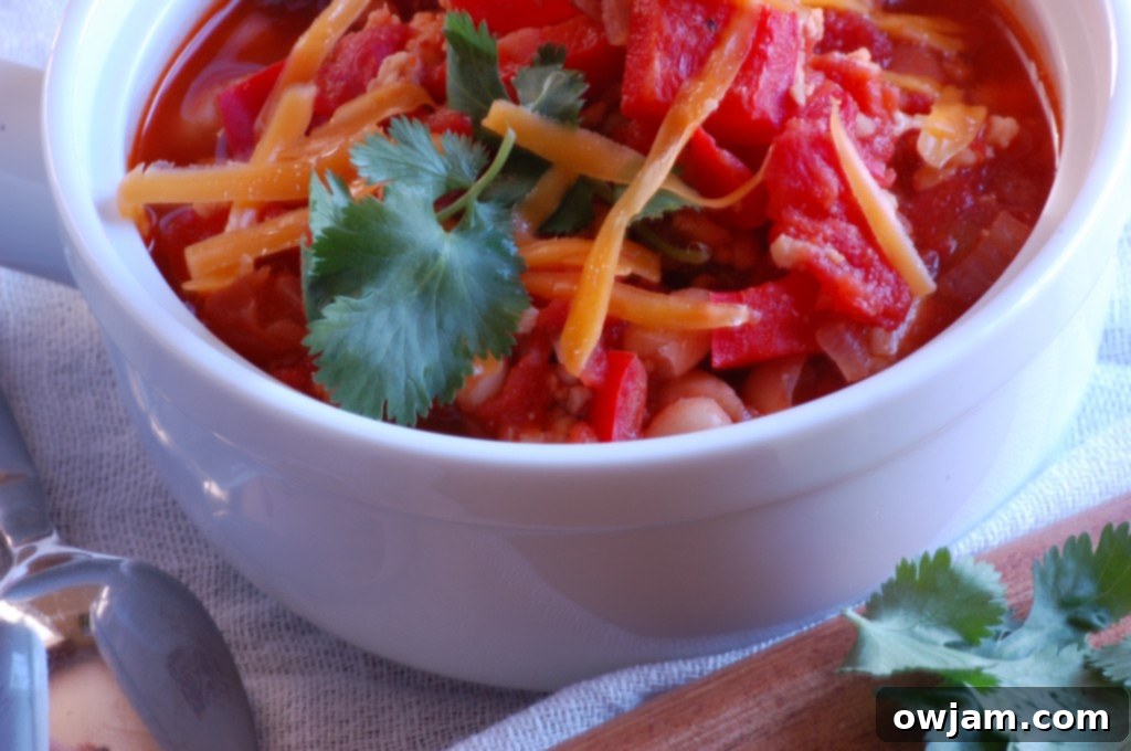 A large, inviting bowl of healthy Turkey and White Bean Chili, garnished and ready to be enjoyed.