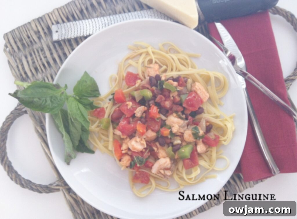 Plate of vibrant Salmon Linguine pasta with fresh salmon chunks, colorful vegetables, and herbs, ready to be served.