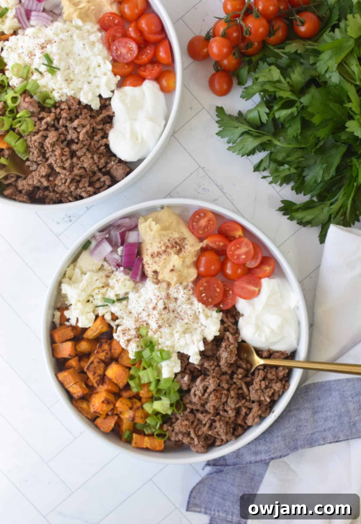 Hearty Sweet Potato Cottage Cheese Ground Beef Bowls 3 Sweet Potato Cottage Cheese Bowls up above with napkin, and fork.