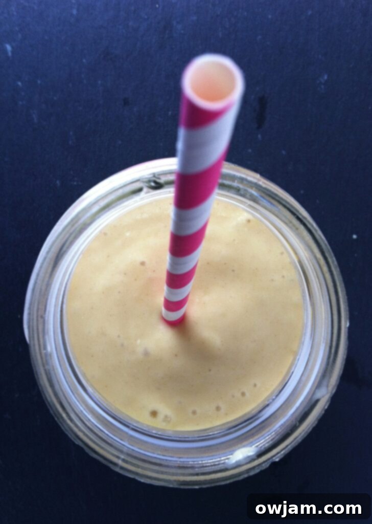 Tropical Mango Banana Oat Smoothie 3 Close up view of the creamy and refreshing Mango Banana Oatmeal Breakfast Smoothie, highlighting its smooth texture and appetizing color.