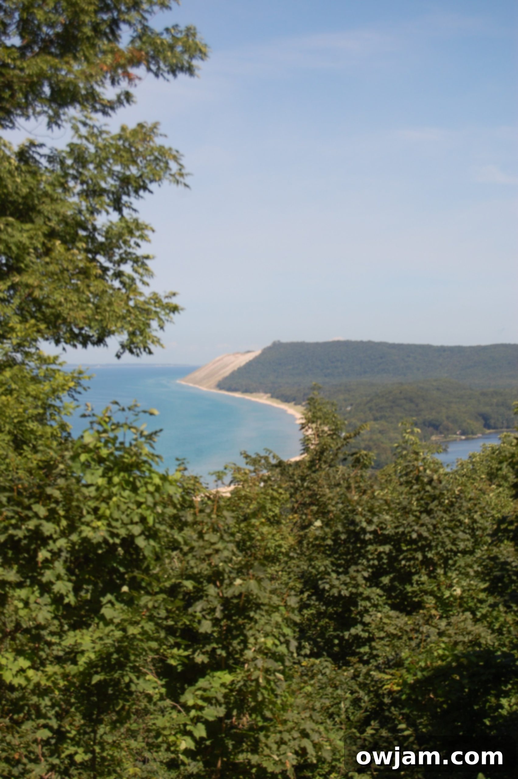 Scenic overlook showing Sleeping Bear Dunes and distant lake.