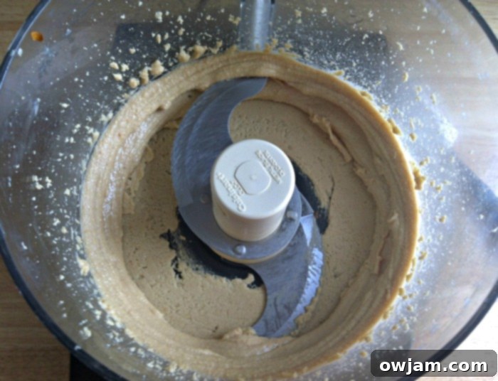 Smooth and creamy homemade peanut butter after being fully processed in a food processor.