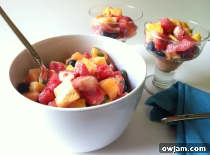 A close-up shot of the fruit salad, perfectly coated in the creamy yogurt honey lemon dressing, ready to be enjoyed.