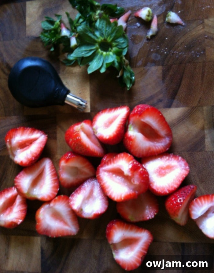 Beautifully sliced strawberries, prepared using the OXO huller, perfect for a fruit salad.
