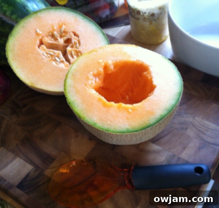 A cantaloupe half with its seeds cleanly scooped out using the OXO fruit scoop, demonstrating efficiency and ease.