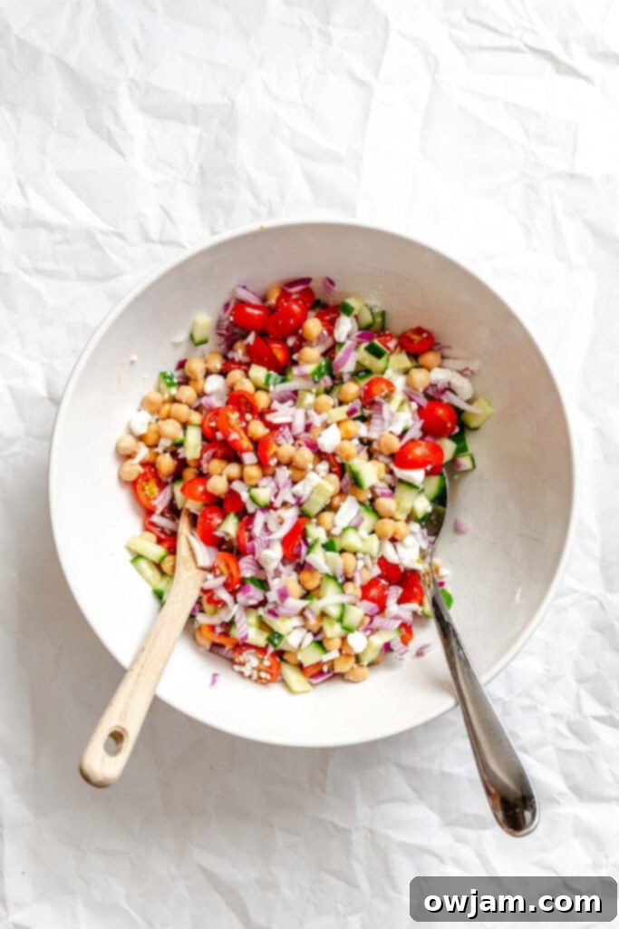 Summer Orzo Pasta Salad ingredients mixed together in a large bowl.