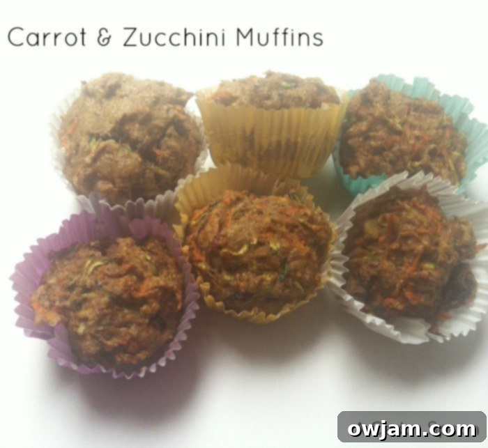 Delicious, moist carrot and zucchini muffins with a golden-brown top, perfect for a healthy breakfast or snack.