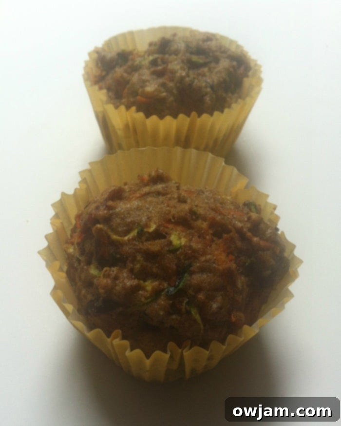 Close-up of freshly baked carrot and zucchini muffins, showing their fluffy texture and delicious ingredients.