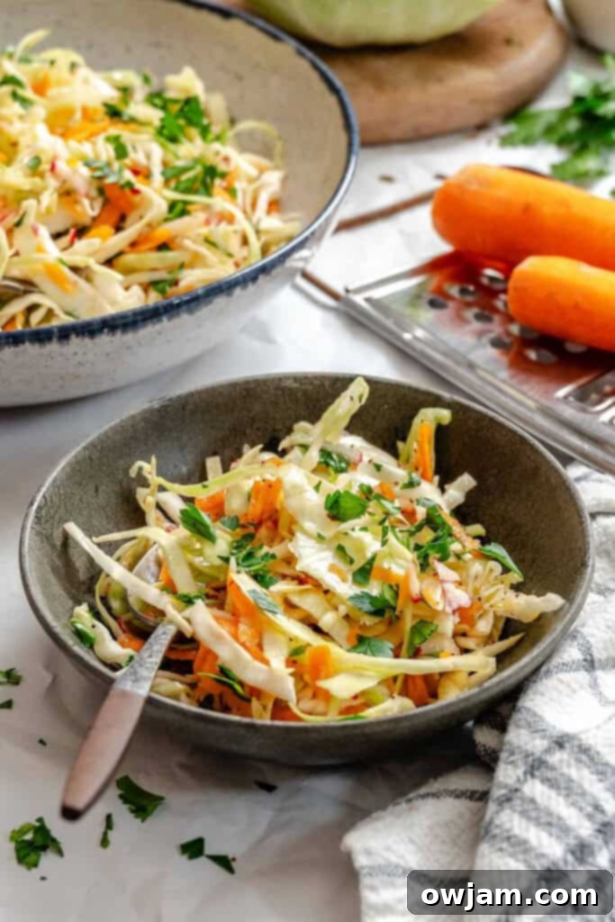 Lightened Up Coleslaw 13 Healthy Coleslaw in a dark bowl, ready to be served, showcasing its appetizing appeal.
