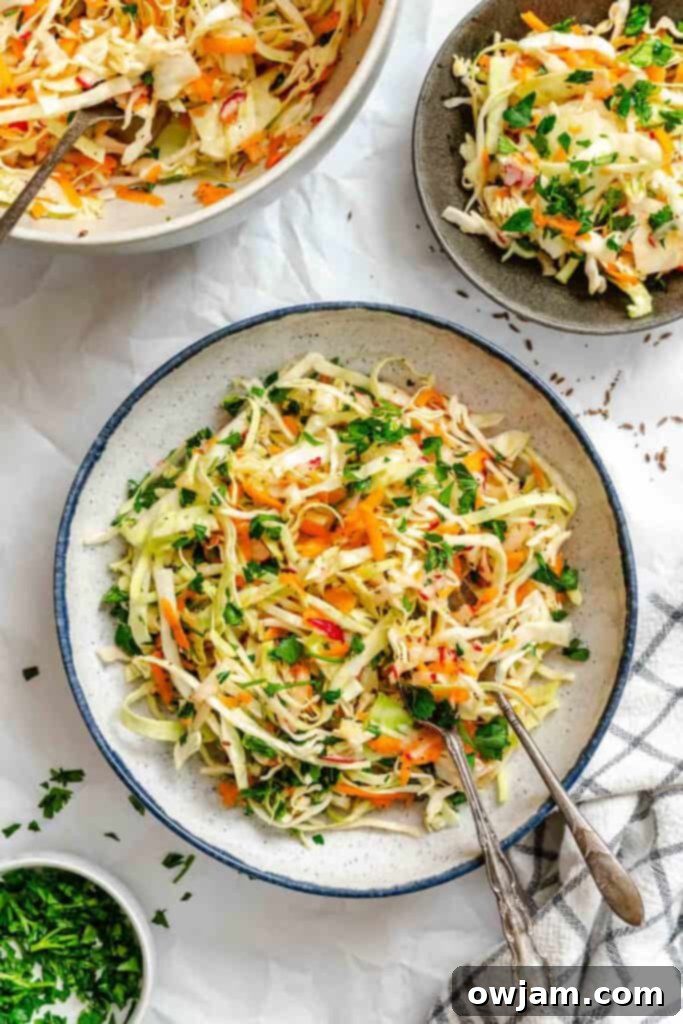 Lightened Up Coleslaw 6 A bowl of healthy coleslaw with a fork, ready to be enjoyed.