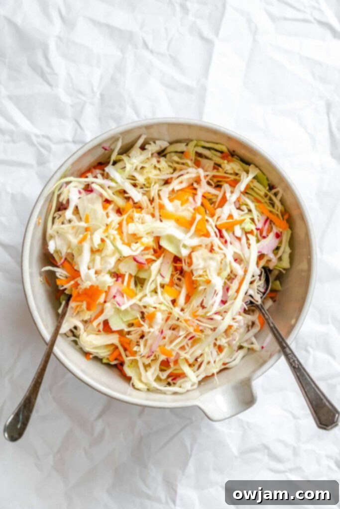 Lightened Up Coleslaw 8 A bowl filled with shredded cabbage, carrots, and radishes, waiting for the dressing.