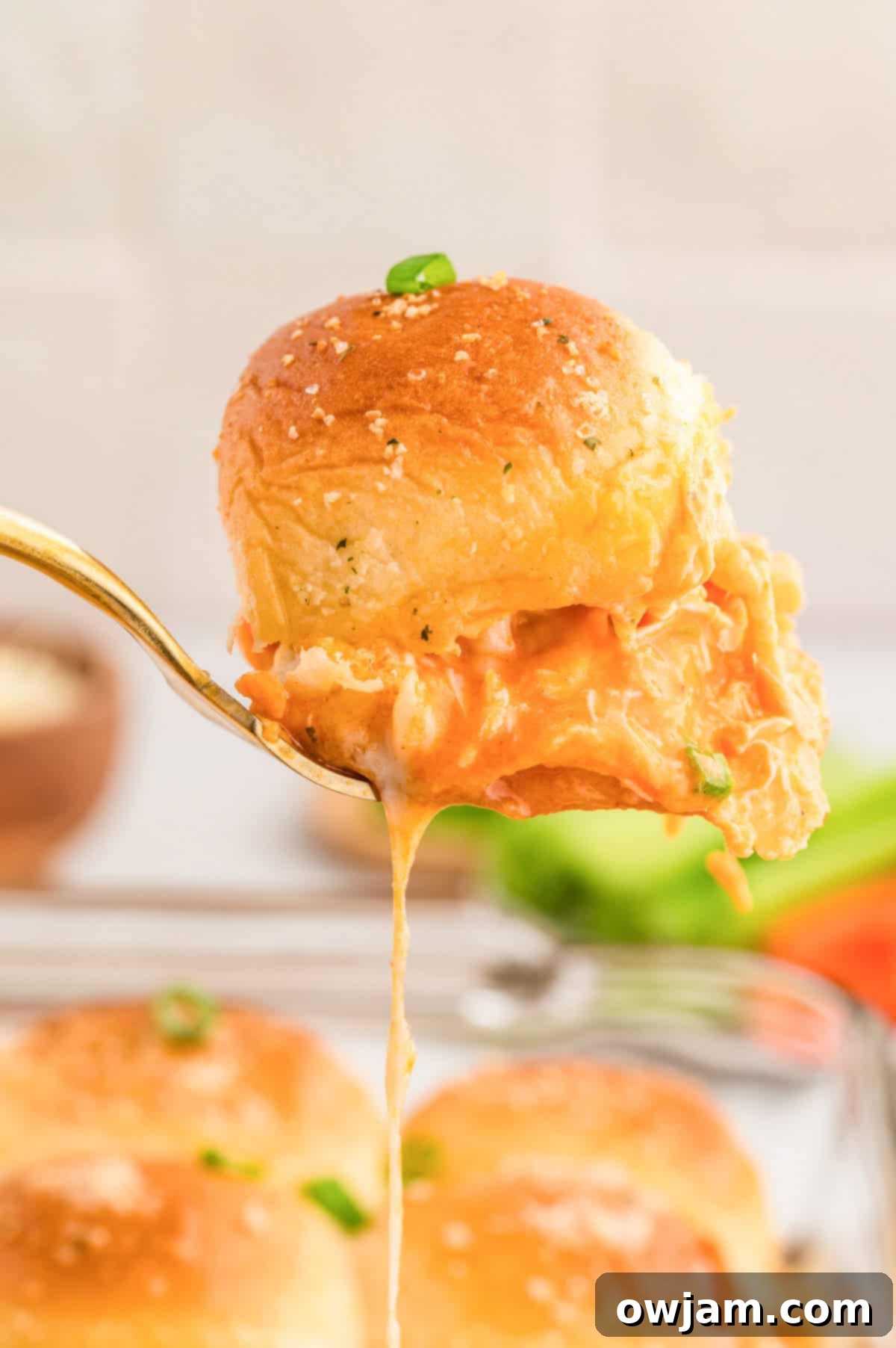 Effortless Buffalo Chicken Sliders 10 Easy Buffalo Chicken Sliders on a serving spoon