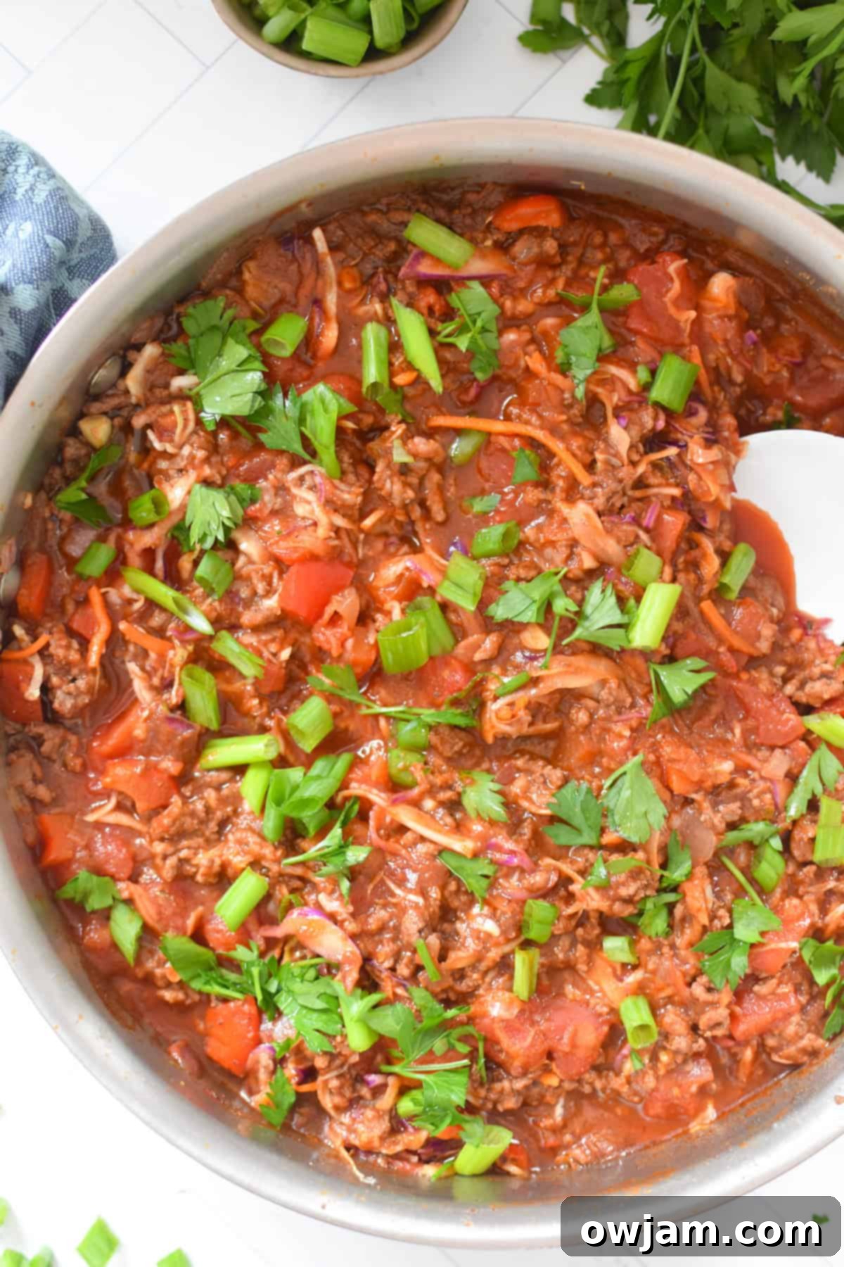 Mediterranean Beef and Cabbage Stir-fry in a skillet with a white spoon 
