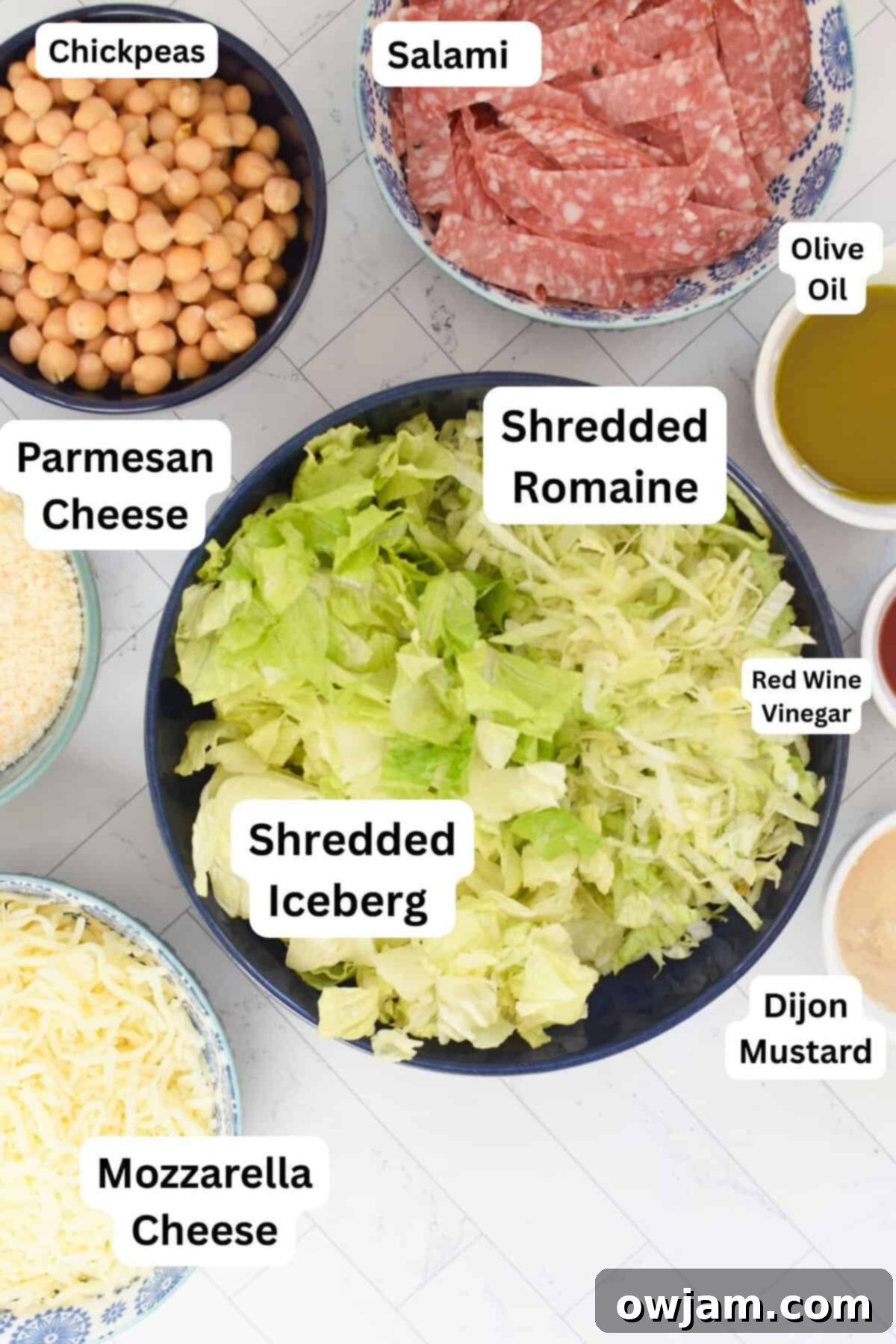 La Scala Style Chopped Salad Made at Home 5 Close-up of fresh ingredients for Copycat La Scala Chopped Salad including romaine, iceberg lettuce, salami, mozzarella, and chickpeas.