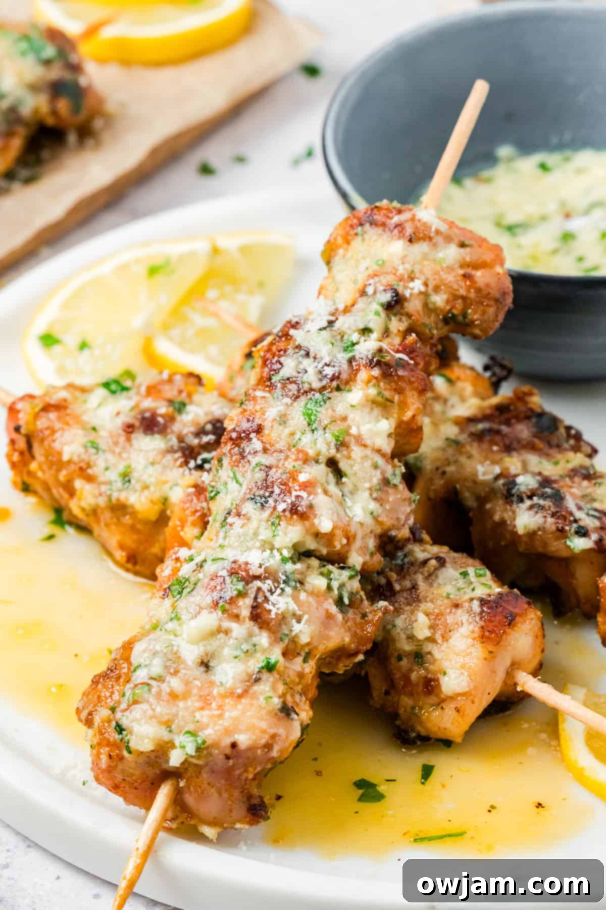 Juicy chicken thighs skewers brushed with garlic parmesan butter sauce
