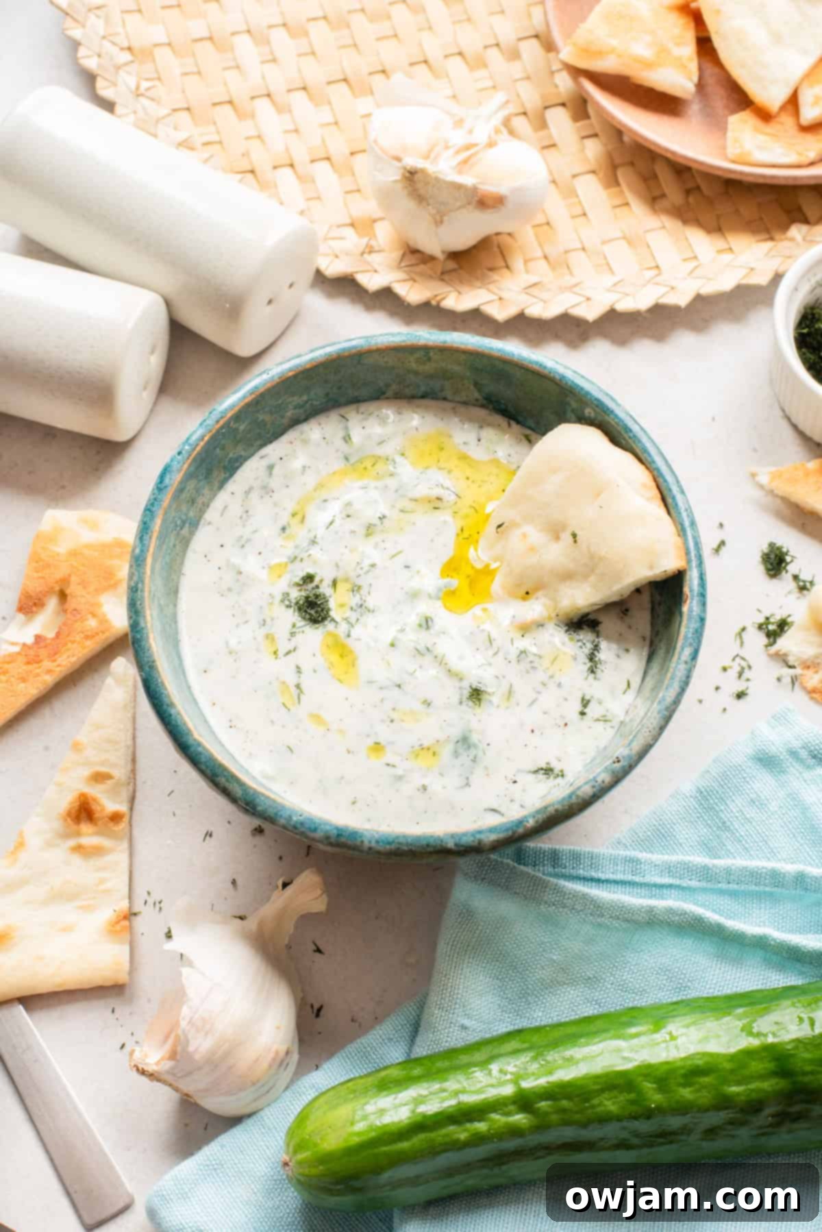 Effortless Authentic Tzatziki: A Simple Greek Delight 2 Traditional Greek Tzatziki sauce in a blue dish