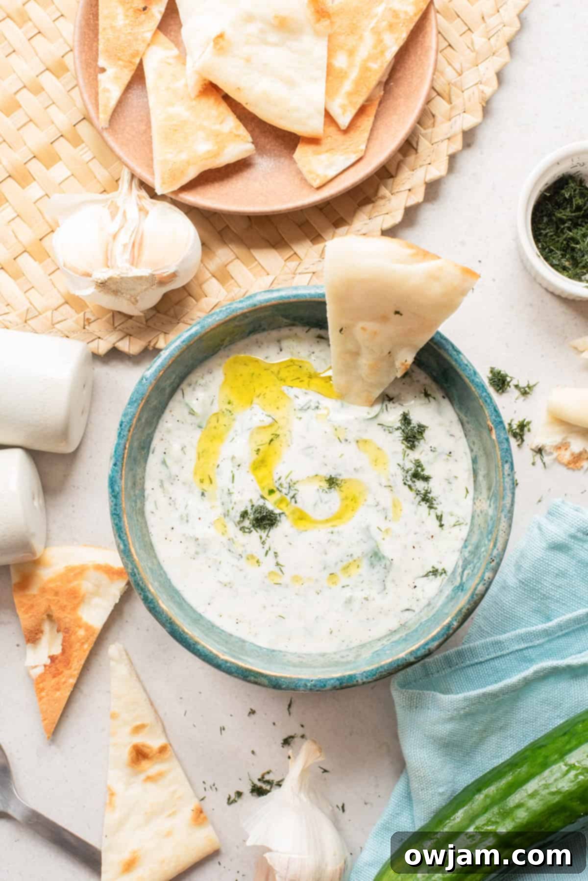 Effortless Authentic Tzatziki: A Simple Greek Delight 7 Cucumber Garlic Yogurt Sauce in a bowl with pita